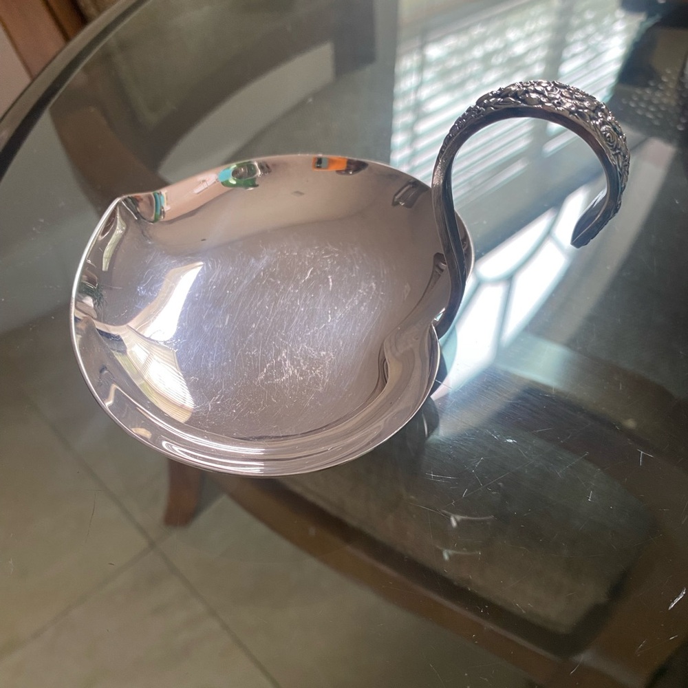 Ornate Silver Ladle with Intricate Handle